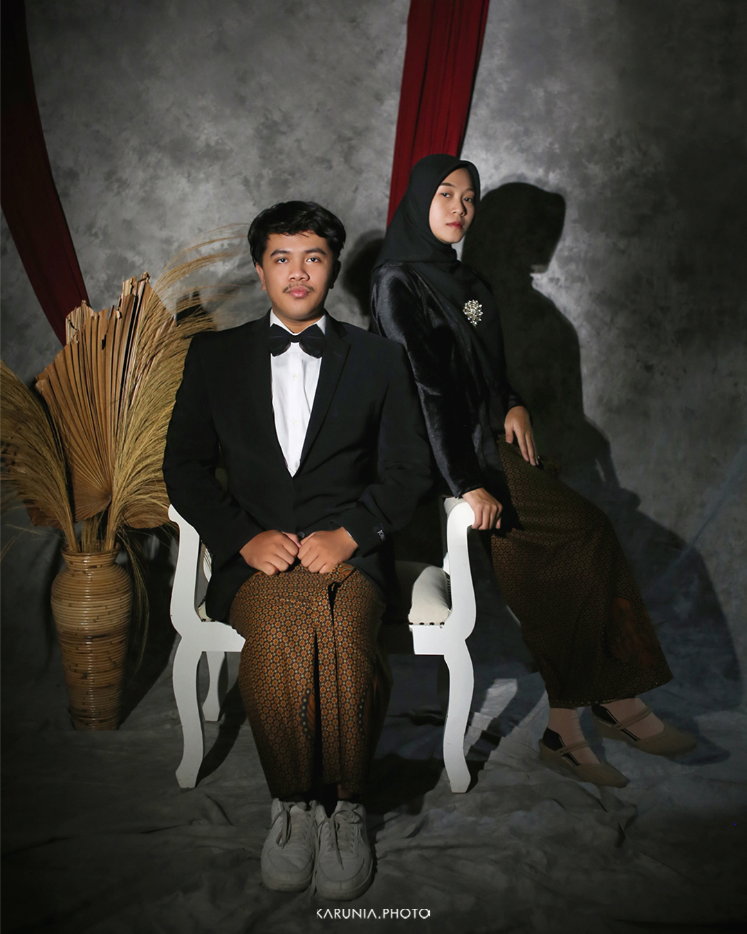 Bride and groom-to-be holding hands and walking along city streets with romantic bokeh lights